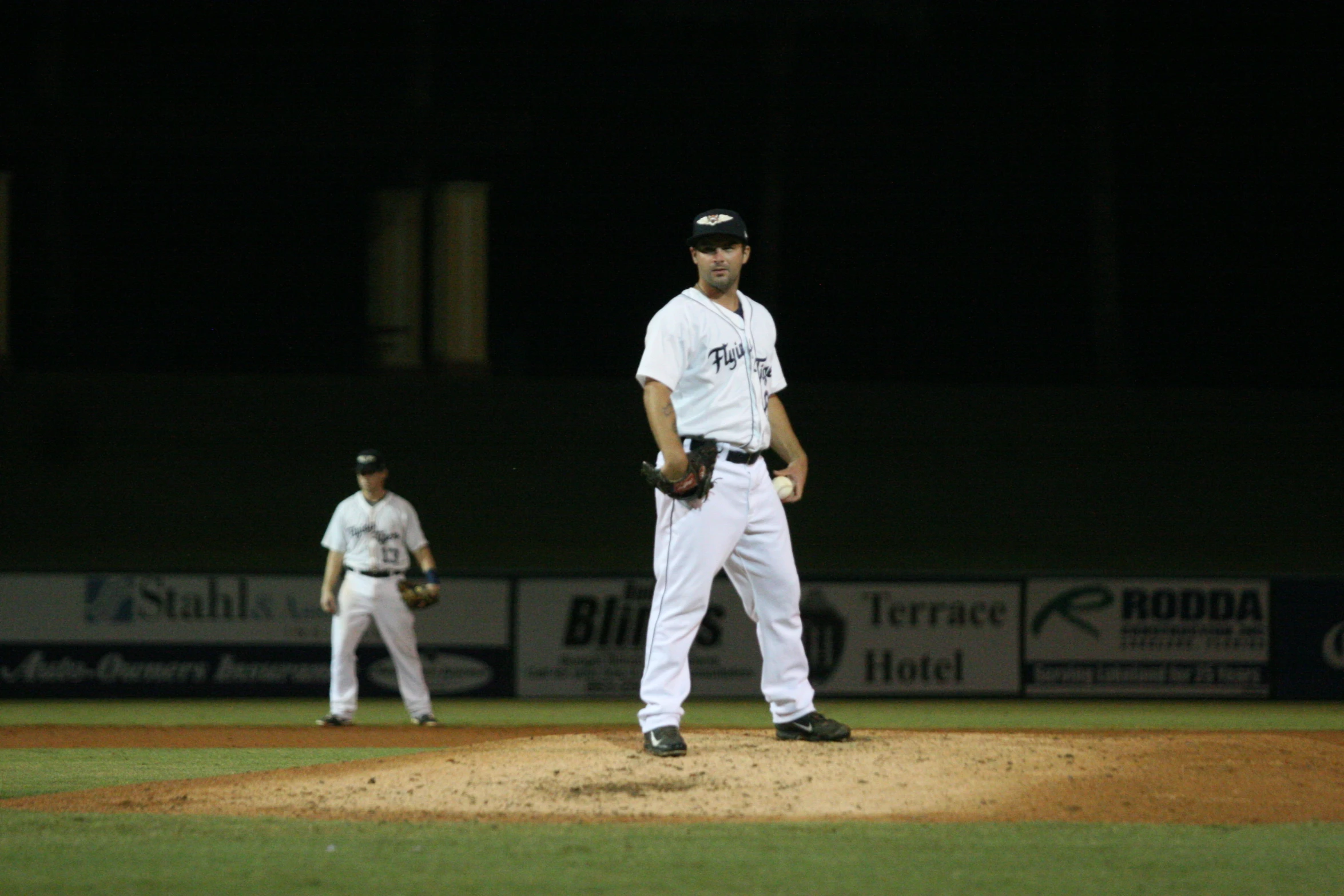 the baseball player stands in the field during the game