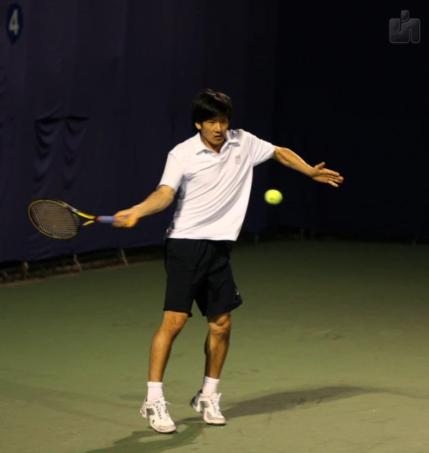 the young man is playing a game of tennis