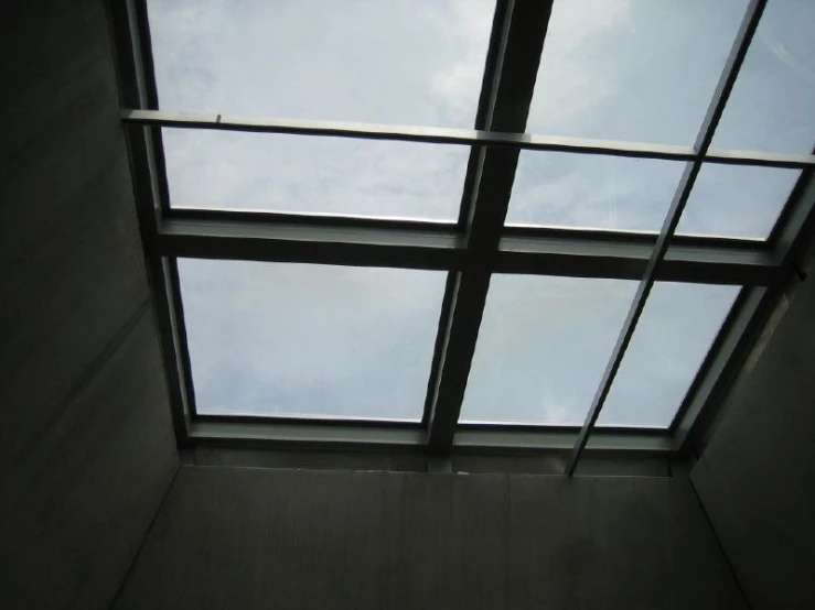 a square window with a sky view is shown
