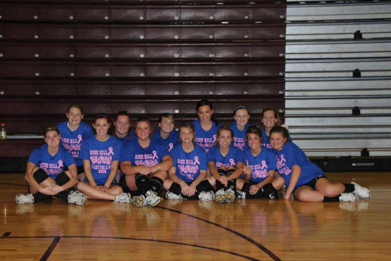 a team pograph on the floor posing for a group po