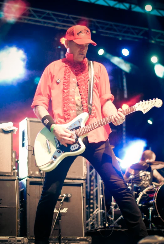 a musician plays a guitar on stage at a concert