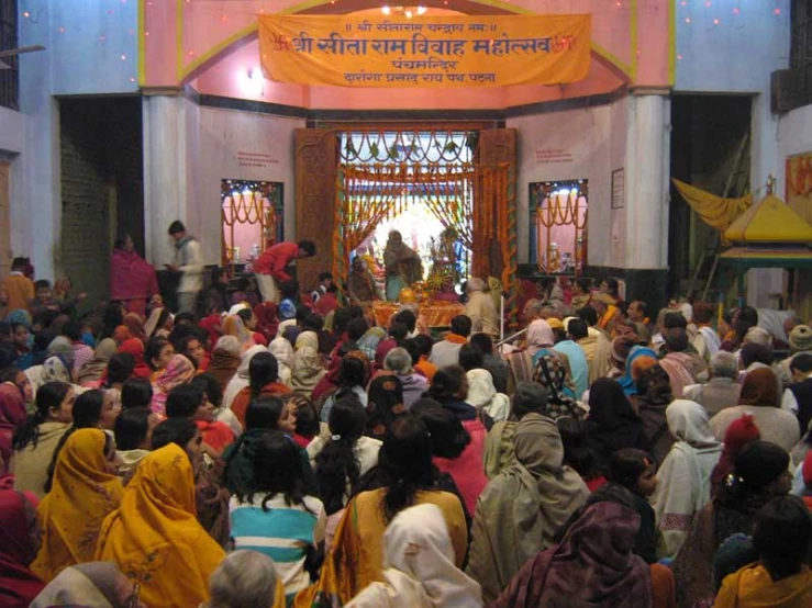 a group of people are standing in front of the altar