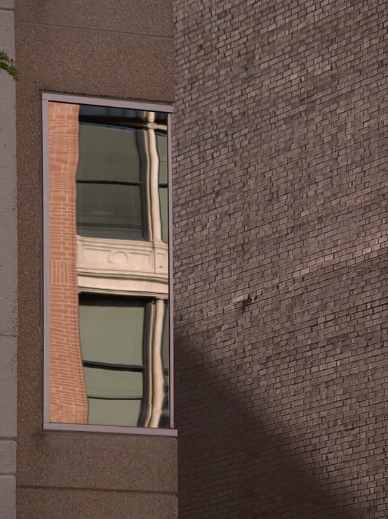 a brown building and reflection in a window