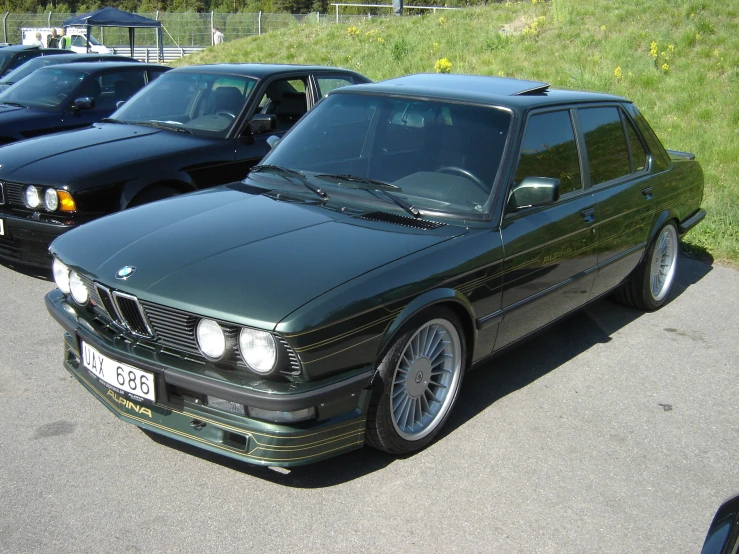 a group of parked bmws sit on the street