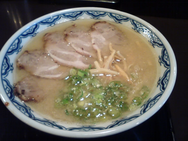 a bowl filled with meat, broccoli and soup