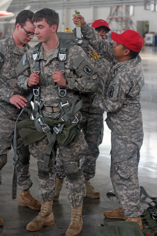 two soldiers are carrying an object around another soldier