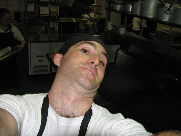 a man poses for a po in front of an oven