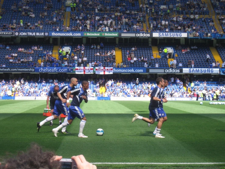 a group of soccer players running around a field