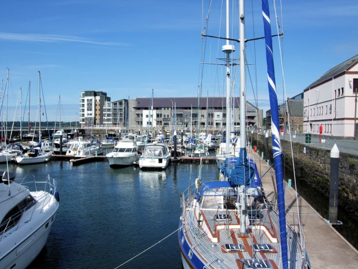 a large number of yachts in the marina with buildings
