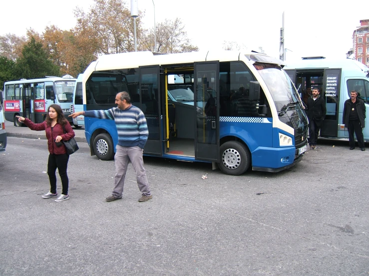 people are walking beside a public transit bus