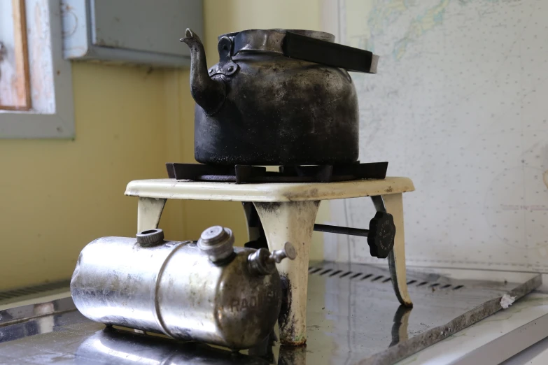 an old metal canister sitting on top of a stove