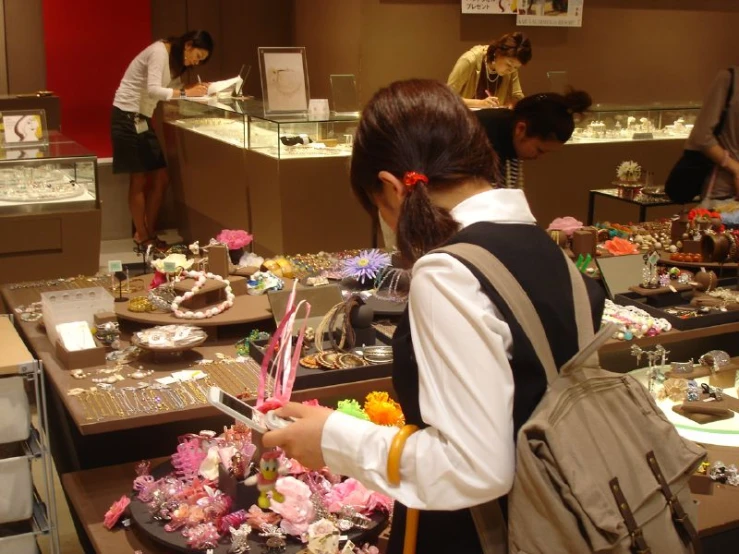 a young lady preparing a display of jewelery and accessories