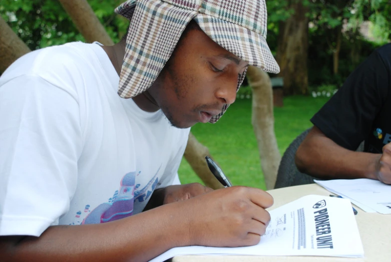 a person sitting down doing soing on paper