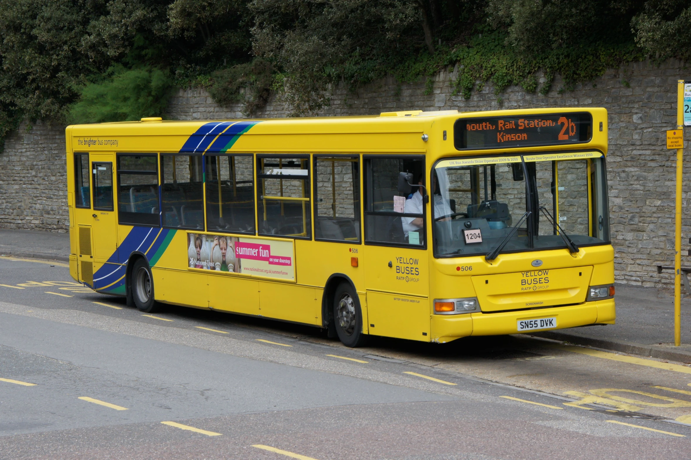 a yellow bus is parked on a street