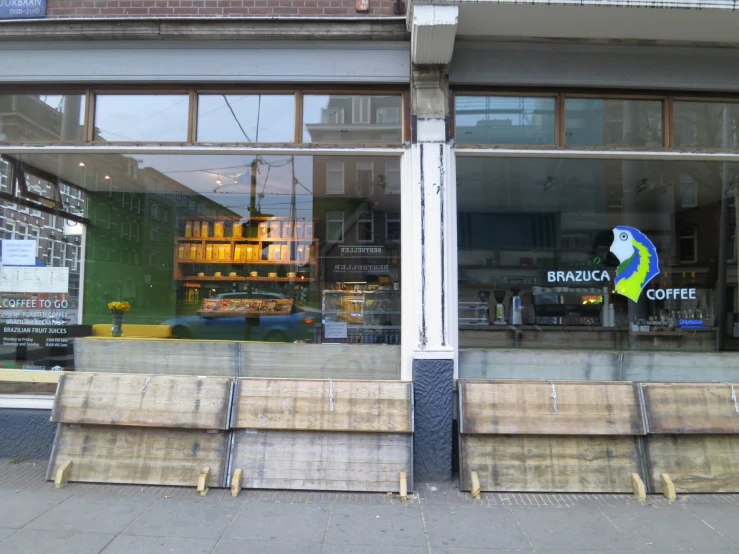 a bench in front of a building on a city sidewalk