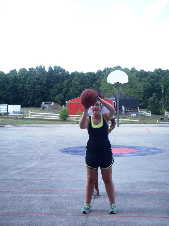 a woman is playing basketball in the court