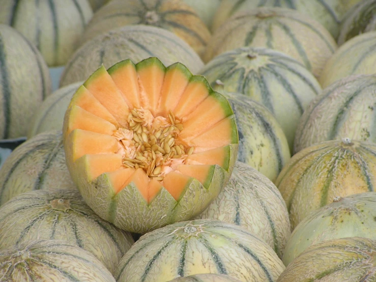 a big pile of watermelons sitting on top of each other