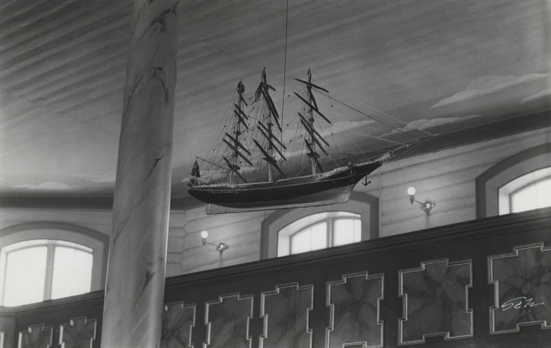 a black and white po of a ship suspended on the ceiling