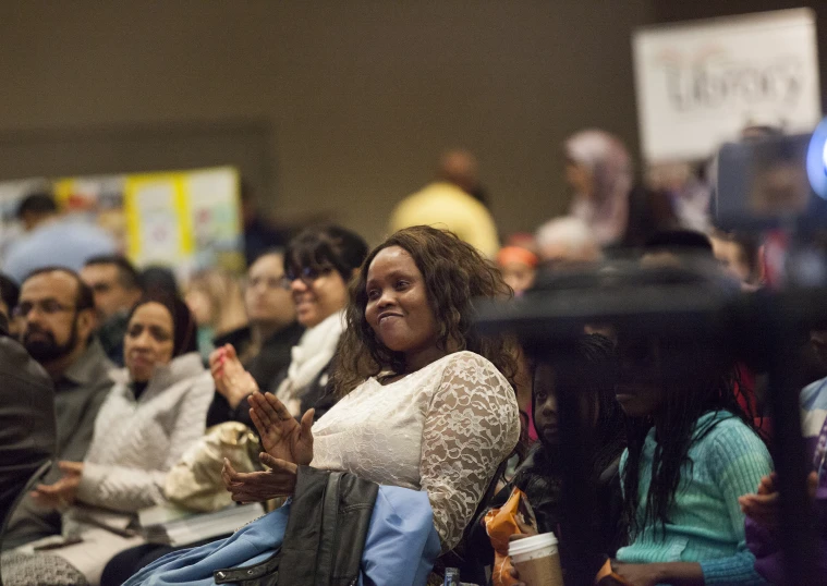 people clapping during a conference with a view of the audience