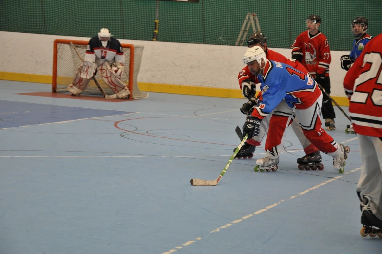 several players in red and blue uniforms during an ice hockey game