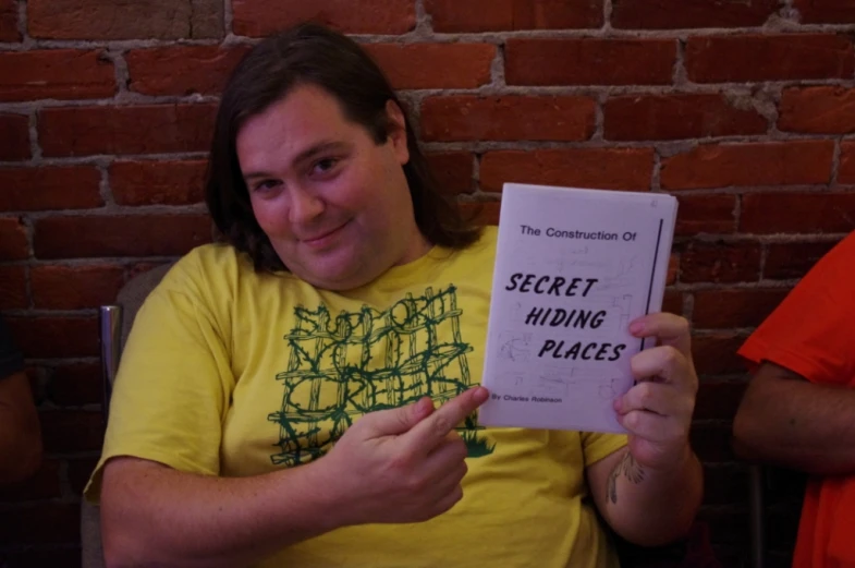 a woman showing off her secret hiding places booklet