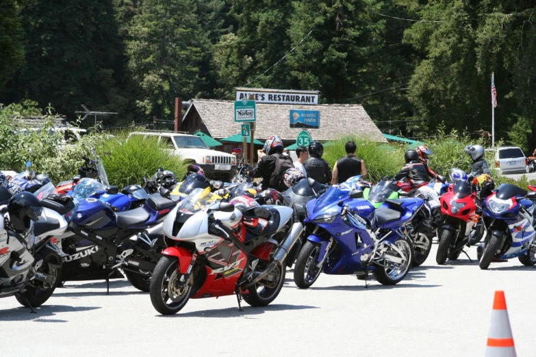 group of parked motorcycles at outdoor stop sign area