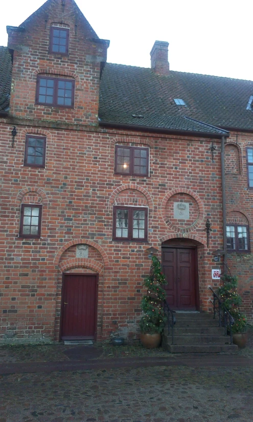 a brick building with red doors and windows