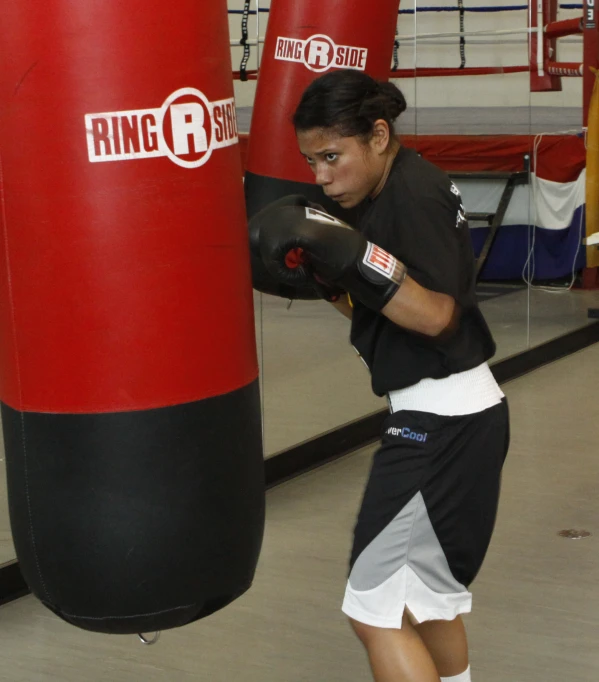 girl in black and white outfit near punching bag