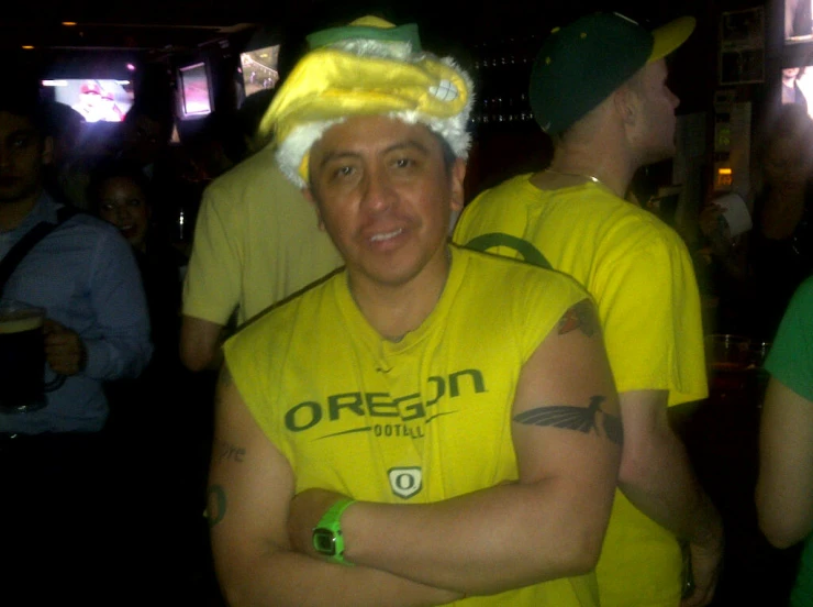 a man in a yellow shirt wearing a festive hat