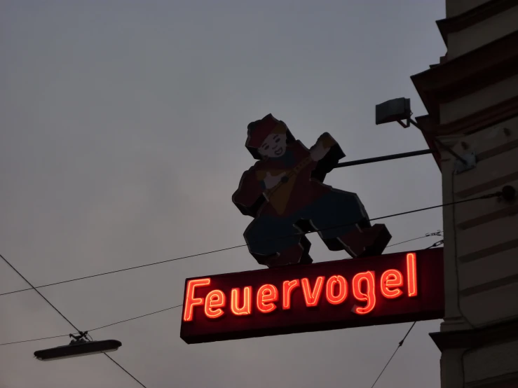 a big stuffed bear that is on the side of a building