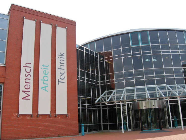 a large building with many windows and white banners on it