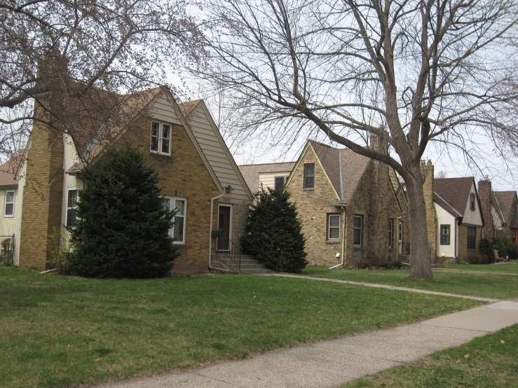 three large brick houses and an empty path