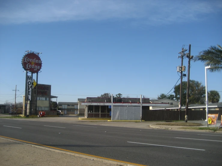 a large sign stands on the side of a road