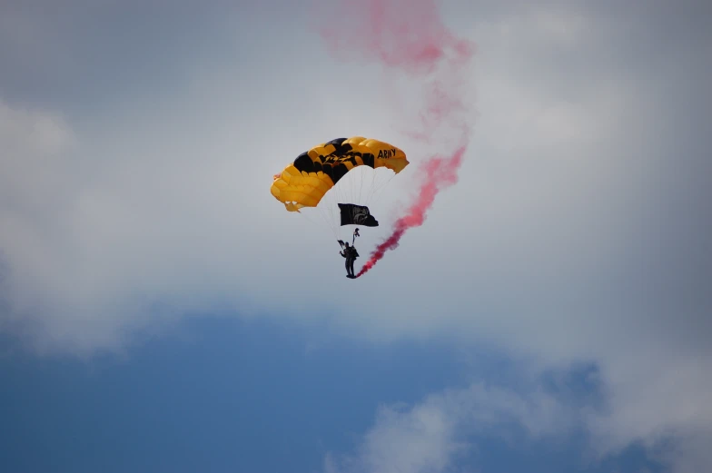 a man is kite surfing with a smoke trail