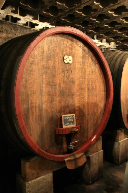 the inside of an old building with wine barrels