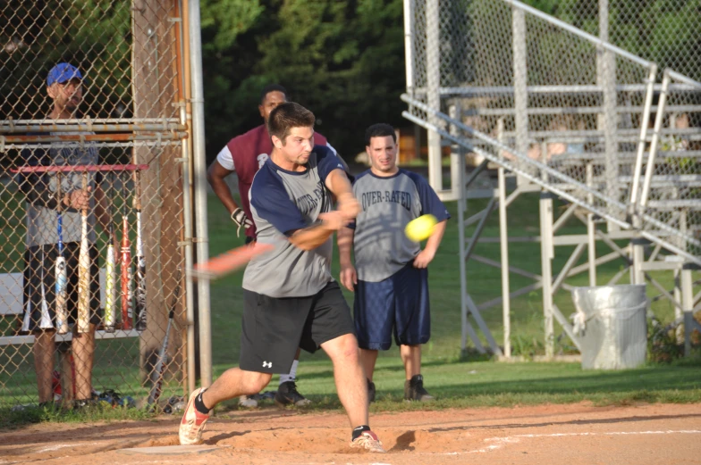 a man swinging a bat at a ball in a baseball game