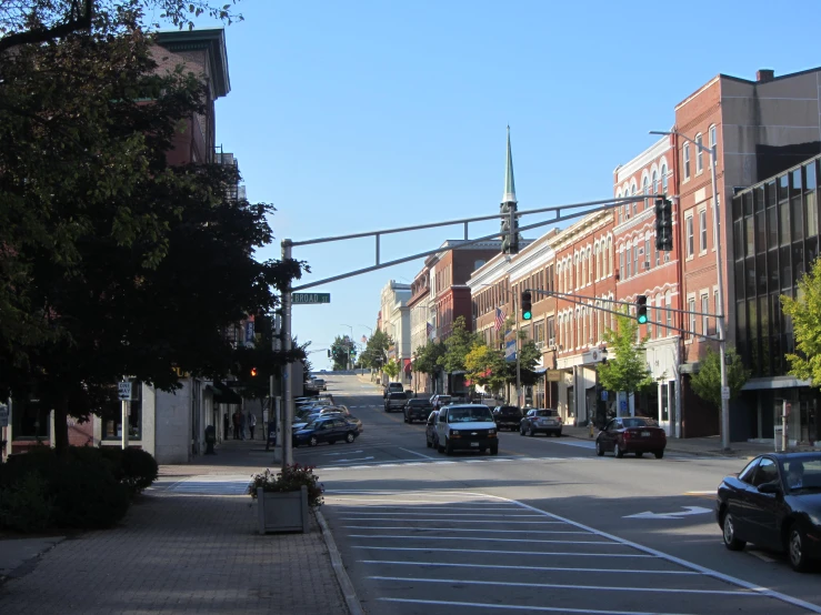 an empty street in the city with cars and traffic lights