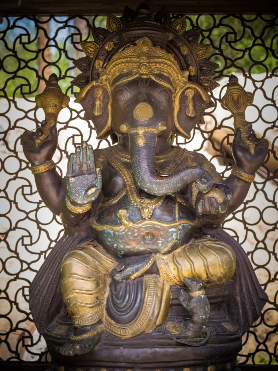 a very large statue sitting in front of a glass wall