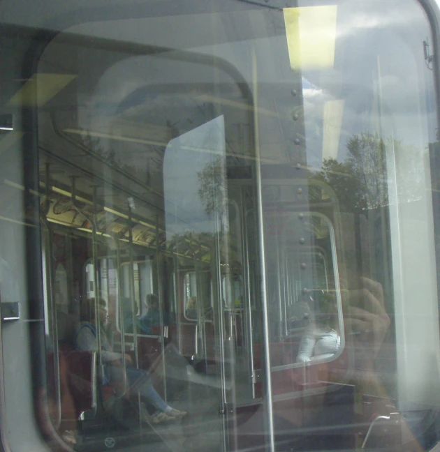 people sitting inside of the train in the sun