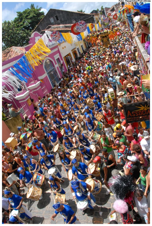 a large group of people in a parade with floats on top of it