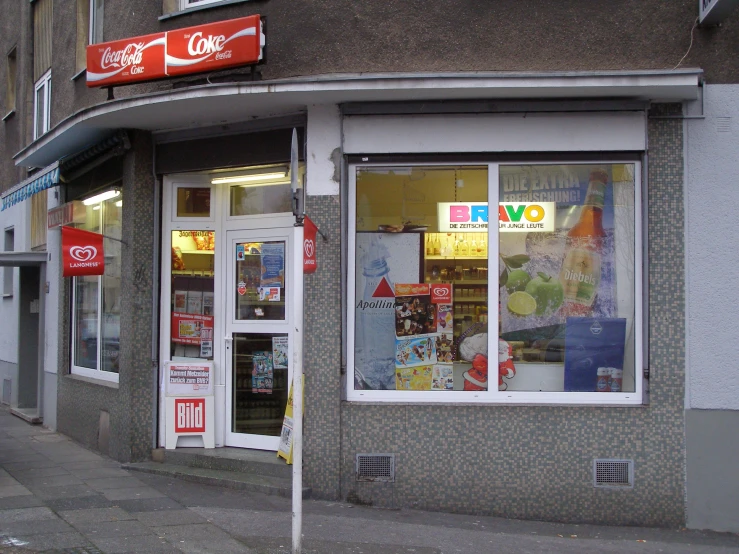 a coca cola store sits on the side of the road