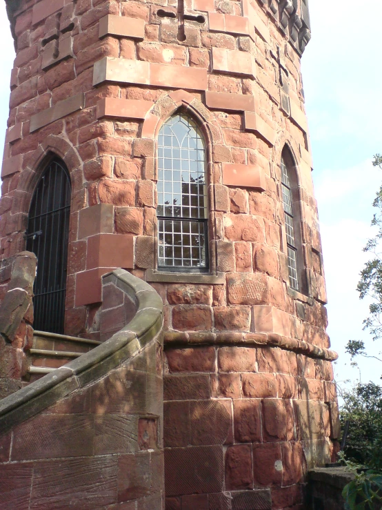there is an old red brick tower with a window