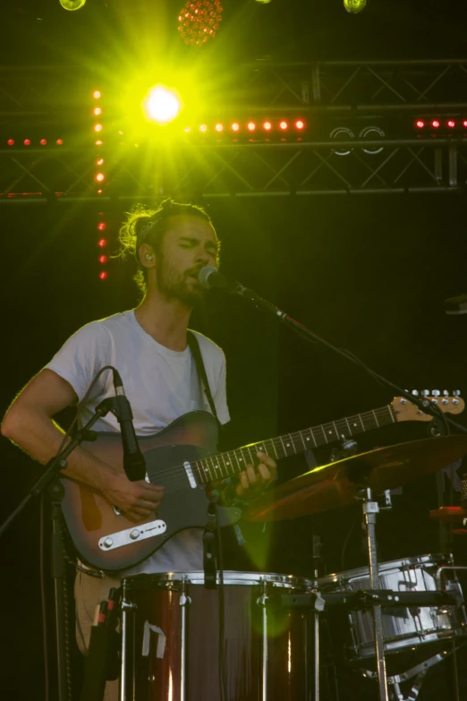 a man that is sitting down with a guitar