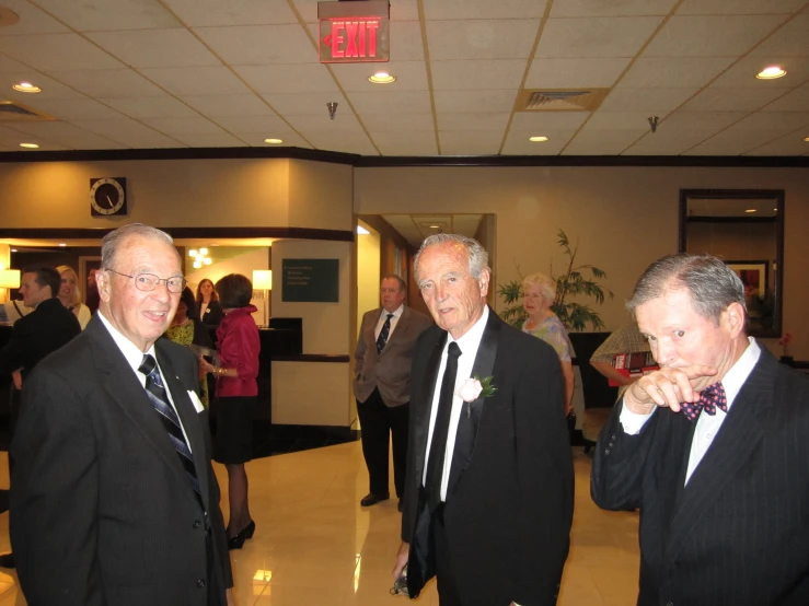 three men in tuxedos at an event