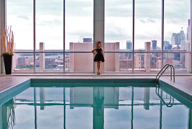 an individual standing by the edge of a swimming pool