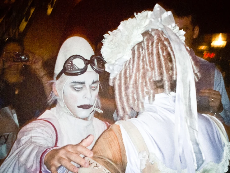 two people dressed in halloween costumes are hugging