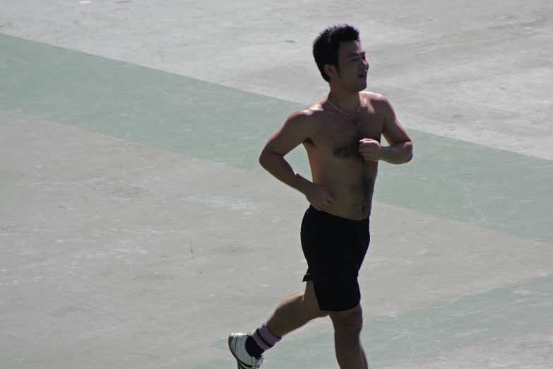 a young man running on a tennis court