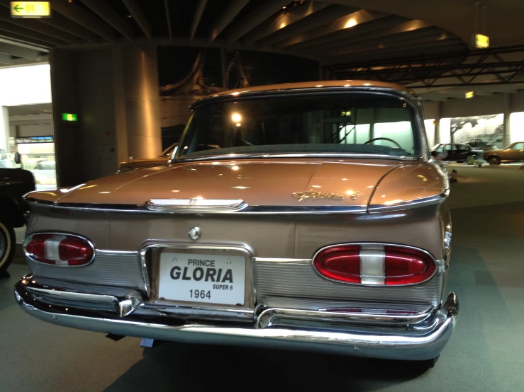 the back view of an old car with a light brown paint