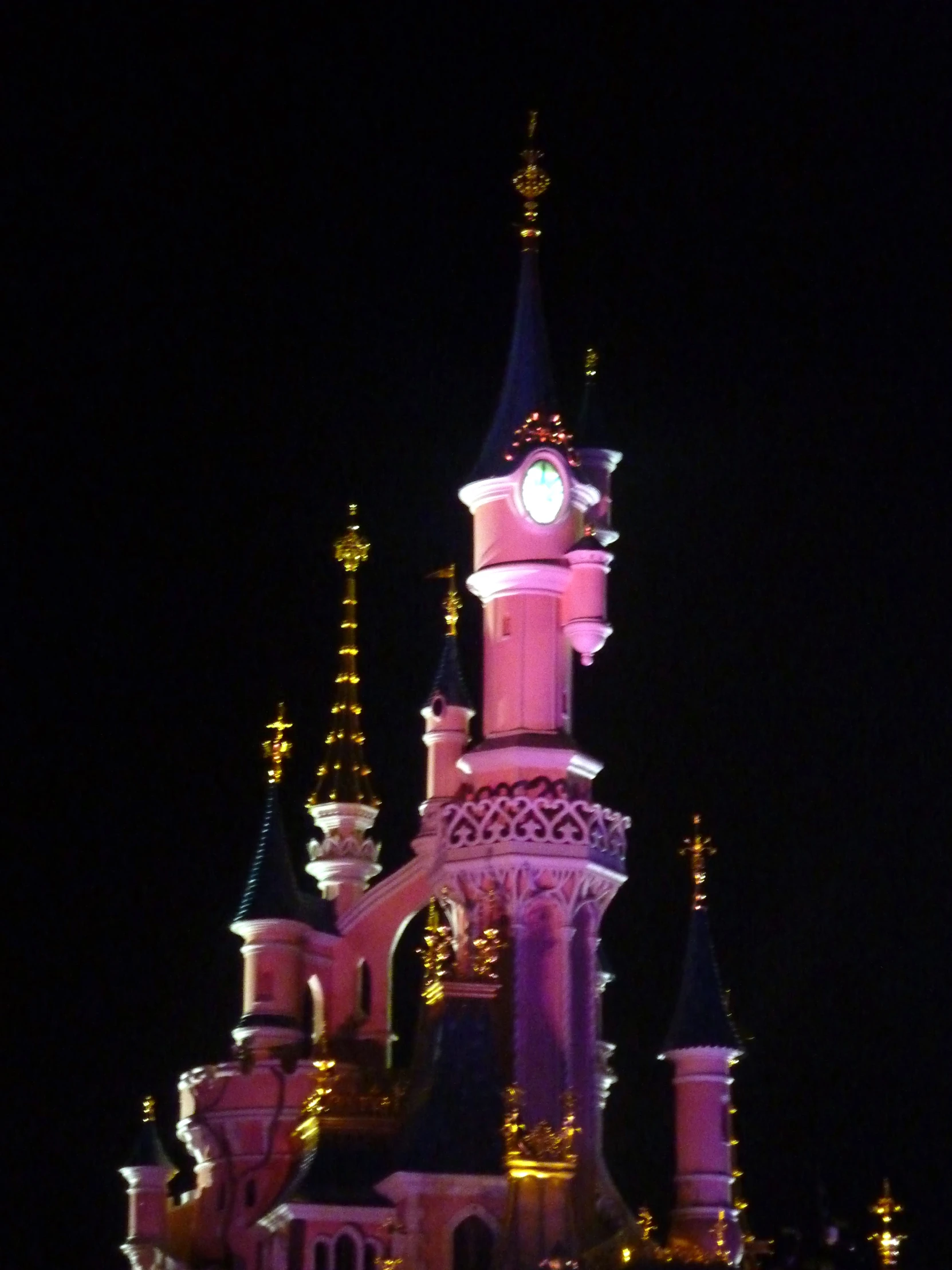 a castle at night with an analog clock