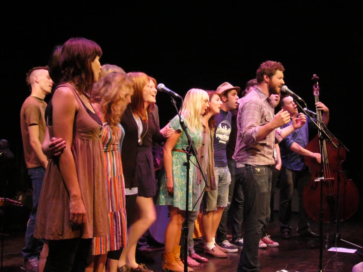 a group of people standing on top of a stage